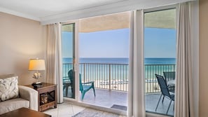 A hotel room with a large sliding glass door leading to a balcony with a view of the beach and ocean. - E804 Balcony overlooks the beach! 3 Pools (Panama City)