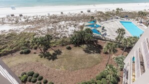 A resort with a pool, beach access, and a view of the ocean.