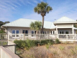 A two-story house with a covered porch and a fenced deck. - Perfect couples retreat close to Shipyard Beach  Club 193 Beachwalk (HIlton Head Island)