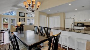 A spacious kitchen with white cabinets, a granite countertop, and a built-in oven. - 15 Lake Village Lane by AvantStay | Golf Course & Lagoon Views (Isle Of Palms)