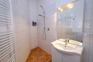 Shower, hair dryer, slippers, towels