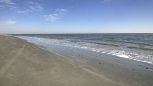 A beach with a clear sky and calm sea. - 102 E Port O Call by AvantStay | Beachfront + Ocean Views + Communal Pool (Isle of Palms)