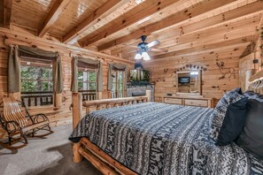 Relax in this charming room with a large bed, comfortable rocking chair, and a television for entertainment.