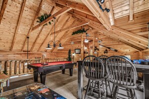 Relax in this cozy space with a pool table and seating area, perfect for socializing.