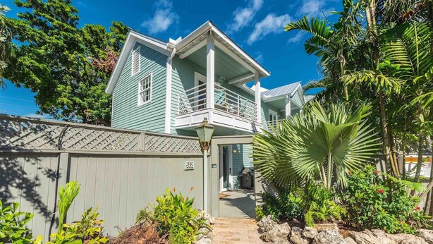 A two-story house with a balcony, surrounded by tropical vegetation. - **ENDLESS SUMMER @ OLD TOWN** New Villa & Pool + Last Key White Glove Service... (Key West)
