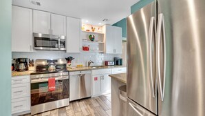 A modern kitchen with stainless steel appliances, white cabinetry, and a microwave above the stove. - **ENDLESS SUMMER @ OLD TOWN** New Villa & Pool + Last Key White Glove Service... (Key West)