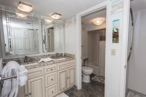 A bathroom with a double sink vanity, a toilet, and a shower. - E405 Lower floor, Great Gulf View, Gated Condo, 3 Pools (Panama City)