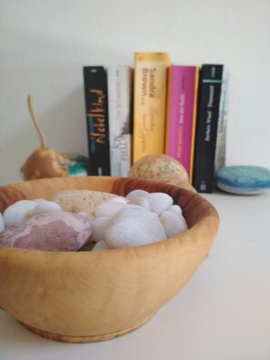 Relax with a calming bowl of stones and a collection of books to enjoy.