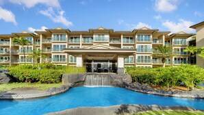 A hotel with a swimming pool, a waterfall, and a well-maintained garden. - Waipouli Beach Resort Exquisite Luxury Garden View Large Yard Perfect for Fam (Kapaa)