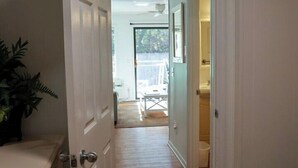 A hallway leading to a bathroom and a patio area. - On the beach 183 SeaSide Villas (Hilton Head Island)