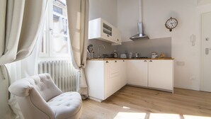 A modern kitchen with white cabinets, a wooden countertop, and a built-in microwave. - Delightful apartment with mezzanine for 4 people, ideal for those who want to visit the city center (Firenze)