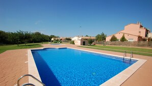 A rectangular swimming pool with a clear blue water surface, surrounded by a paved deck. - Daró 2D 167 - Community pool, corner house, A/C (Torroella de Montgri)
