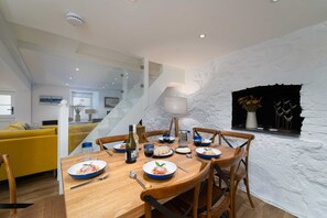 Enjoy meals in this stylish dining area with a fireplace and comfortable seating.