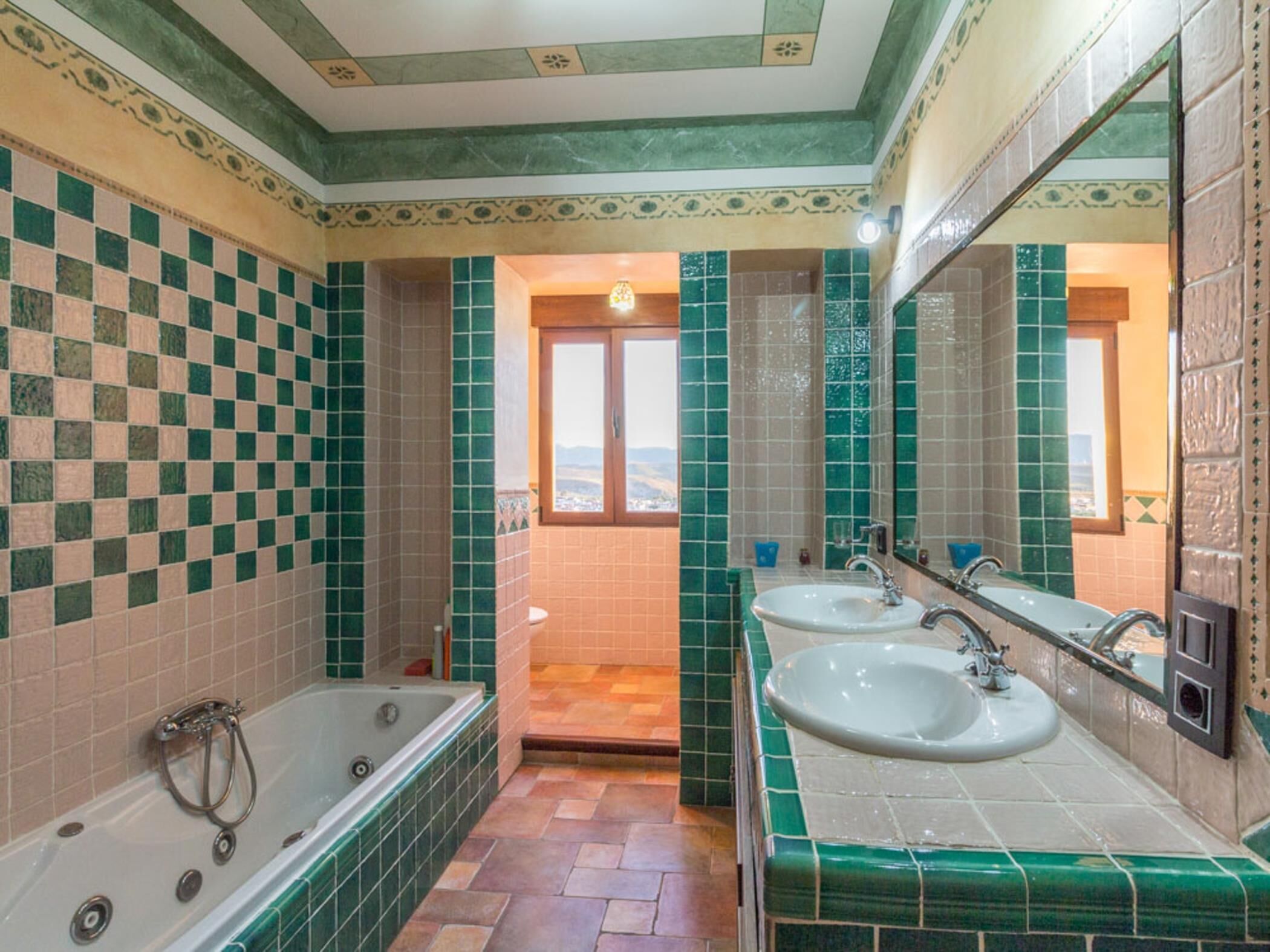 A bathroom with two sinks, a bathtub, and a shower.