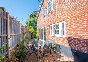 Enjoy outdoor living in this traditional home with a covered patio and garden.