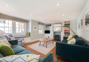 Relax in a comfortable seating area with a sofa and armchairs, perfect for unwinding or socializing.