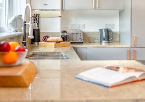 Enjoy cooking in this well-equipped kitchen with a toaster, coffee maker, and granite countertop.