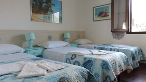 A hotel room with two beds, each with a blue patterned bedspread, white pillows, and matching nightstands with teal lamps. There are two wall-mounted paintings, one of a beach and one of a beach scene with a person. - Beach house with private beach access  (Perd'e Sali)