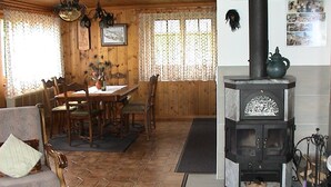 Una habitación acogedora con una mesa de comedor de madera, sillas, un sofá y un estufa de leña.