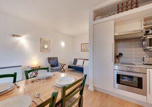 Enjoy meals in this dining area with a table for four and a cozy seating area nearby.