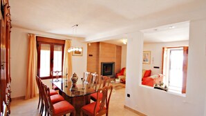 A dining area with a glass table, wooden chairs, and a chandelier. - Finca La Verema - holiday home with private swimming pool in Benissa (Benissa)