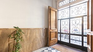A checkered floor, a wooden door with a metal gate, and a potted plant. - Your own private view over St.Peter! (Rome)