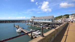 A coastal pier with a building, docked boats, and a walkway. - The Salt Pot -  a cottage that sleep 6 guests  in 3 bedrooms (Ventnor)