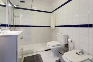Shower, hair dryer, towels, toilet paper