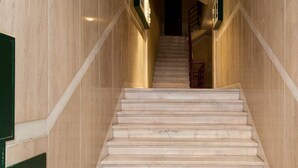 A marble staircase with a handrail and a door at the top. - JOIVY Stunning apt near Avenida da Liberdade (Lisboa)
