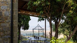 An outdoor dining area with stone walls, a gazebo, and a view of the countryside. - Casale Santa Francesca - Country Villa with swimming pool in Orcia Valley, Tuscany (Campiglia D'orcia)