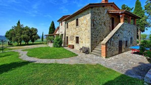A stone house with a stone staircase leading to the entrance, surrounded by a well-maintained lawn and trees. - Casale Santa Francesca - Country Villa with swimming pool in Orcia Valley, Tuscany (Campiglia D'orcia)