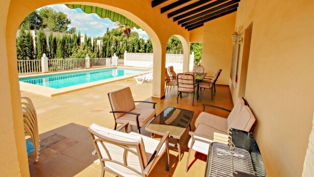 An outdoor patio with a pool, lounge chairs, and a grill area. - Linea - sea view villa with private pool in Teulada (Teulada)