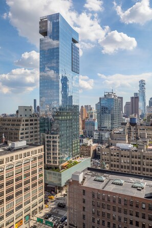 A high-rise building with a glass facade, surrounded by other buildings in an urban setting.