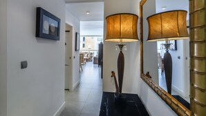 A hallway with a large mirror, a lamp, and a framed picture on the wall. - Espigon Central - Punta del Moral Beach PEHC14P79 (Punta del Moral)