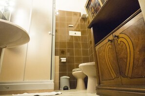 A bathroom with a sink, toilet, and shower.