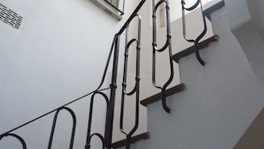 A staircase with metal railings and a window at the top. - Spacious and Beautiful 60 sqm Apartment in the Very Heart of Bologna (Bologna)
