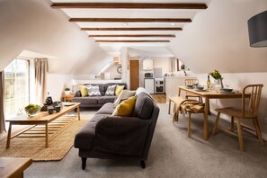 A cozy loft-style apartment with a dining area, kitchen, and living room.