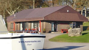 A boat docked in front of a building with a website address and a website name visible.