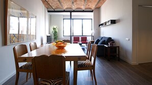 A dining area with a brick ceiling, a large window, and a modern interior design.