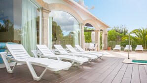 A poolside area with white lounge chairs and a small pool. - VILLA ROMANA BONAIRE - Villa with private pool in Bonaire (Alcúdia). Free WiFi (Alcúdia)