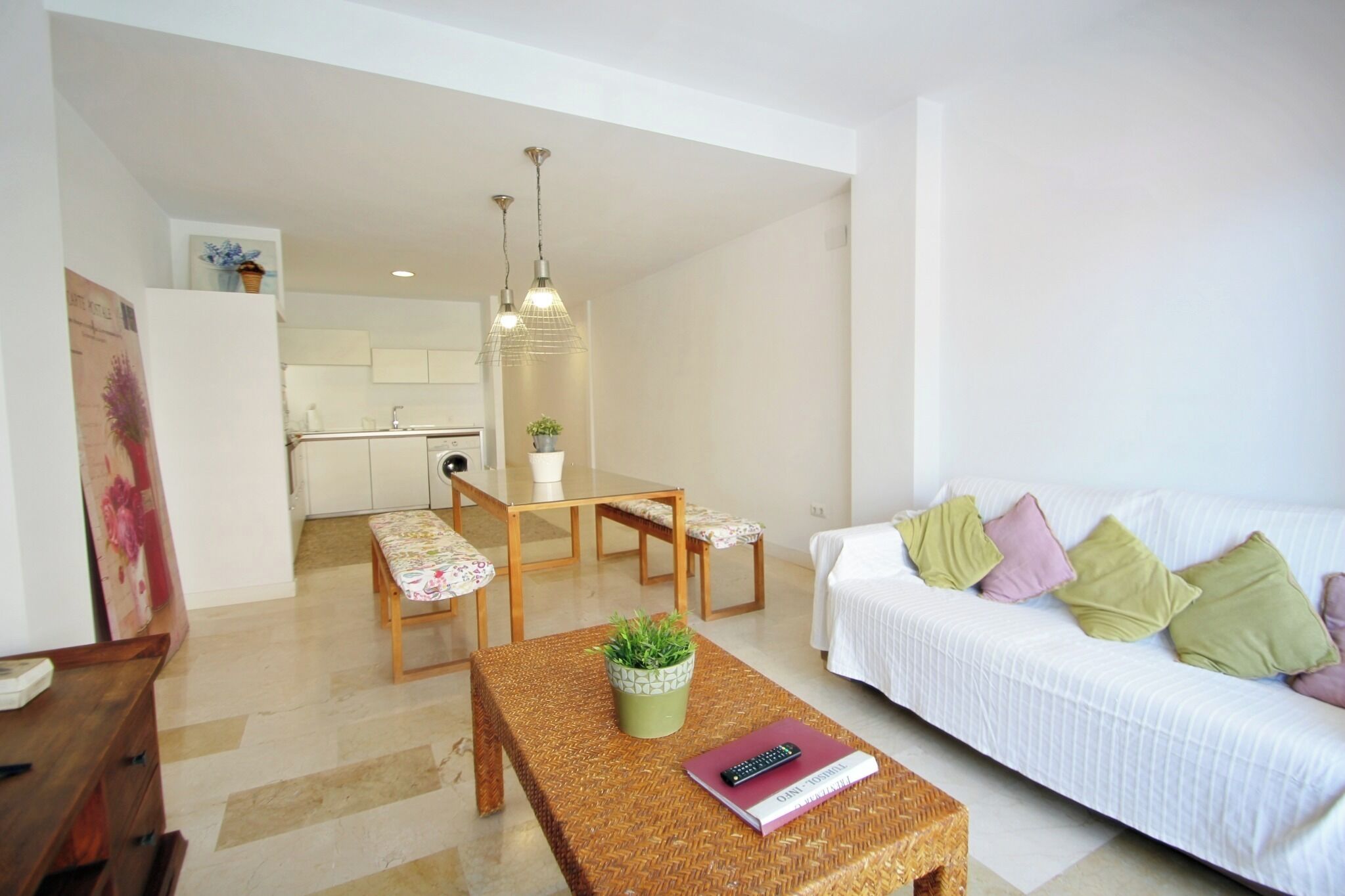 A modern living room with a sofa, a dining table, and a coffee table.