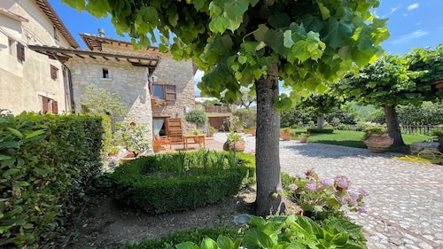 A two floor detached house with a patio/terrace & a large garden