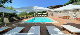 A two floor detached house with a patio/terrace & a large garden