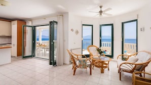 A spacious living area with a balcony, wicker furniture, and a view of the sea. - Beachfront Villa Shades of Summer (Podaca)