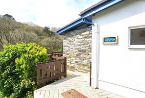 Enter the serene Garyvoe estate, surrounded by lush greenery and a picturesque hilly landscape.