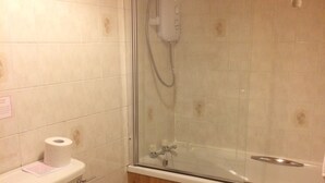 A bathroom with a toilet, a glass-enclosed shower, and a bathtub. - Pond Cottage, Carmichael Country Cottages. Pets welcome. (Biggar)