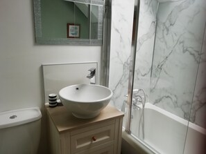 A bathroom with a white sink, a mirror, a toilet, and a shower. - Crinan Canal Cottage No8, Kilmartin (Lochgilphead)