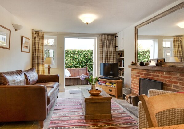 Relax in this inviting living room with a sofa, coffee table, and fireplace.