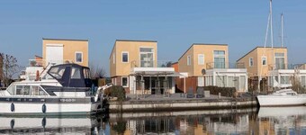 Luxury holiday home with fully hardened waterfront terrace. The long outdoor table under the terrace