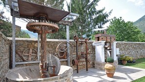 Eine Außenwasserpumpe mit Steinmauern und Holzbauten.